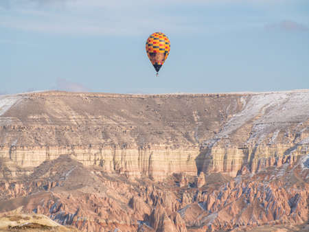 Goreme, Turkey - January 11, 2020: Colorful balloons over volcanic rocks in Cappadocia. Turkey.のeditorial素材