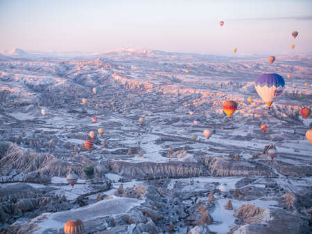 Goreme, Turkey - January 11, 2020: Colorful balloons over volcanic rocks in Cappadocia. Turkey.のeditorial素材