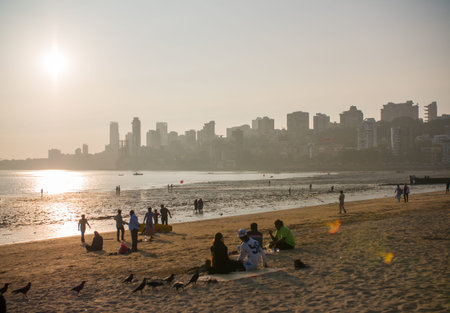 Mumbai, India - December 17, 2018: Evening Mumbai, Chowpatty beach. View of Malabar hill at sunset.のeditorial素材