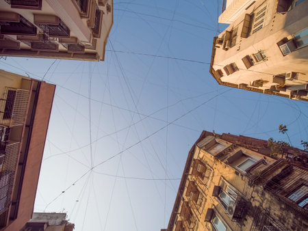 Electric wires hanging on the buildings in Mumbai.の写真素材