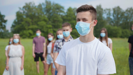 Pandemic distance concept. Group students stand at a distance from each other.