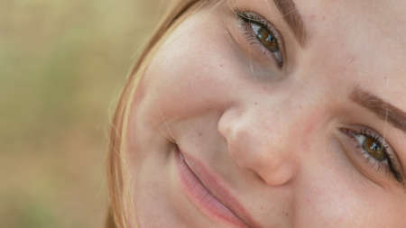 Close up of young smiling girl face.の写真素材