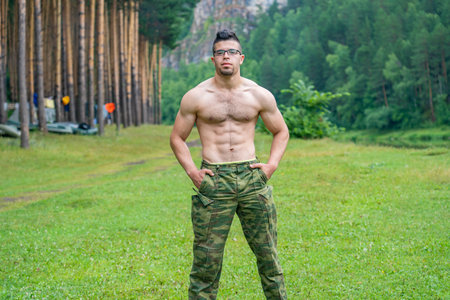 Handsome athletic Arab guy without a T-shirt on the background of the beautiful nature of the South Urals.の写真素材