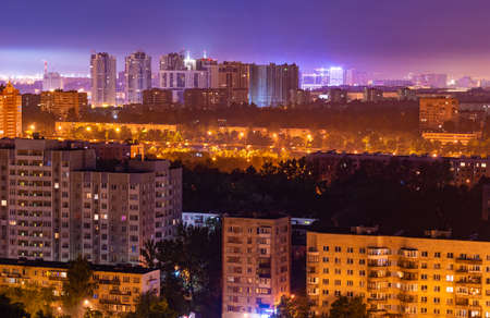 Night colorful windows lights of the high-rise residential building in city sleeping areaの写真素材