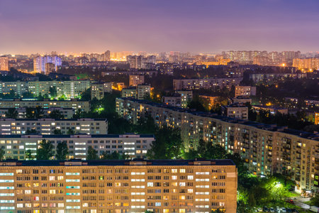Night colorful windows lights of the high-rise residential building in city sleeping areaの写真素材
