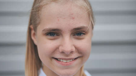 Portrait of a smiling bright teenage girl. Face close-up.の写真素材