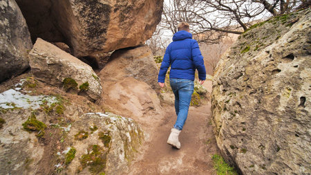 A tourist strolling among the rocks in the Ihlara Valley in Cappadocia, Turkey.の写真素材