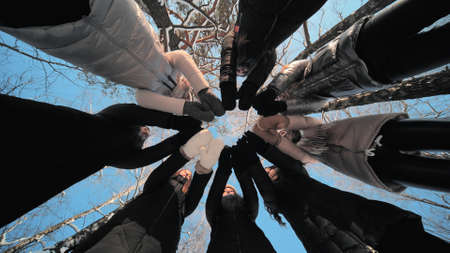 Group of young people having a rest outdoor in winter.の写真素材