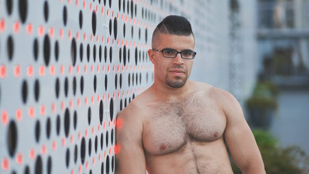 Muscular young man Arab posing against white background.の写真素材