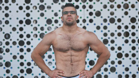 Muscular young man Arab posing against white background.の写真素材