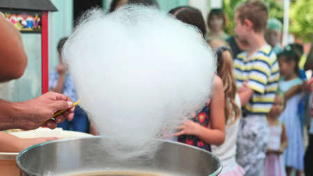The process of making cotton candy outdoors for children.の写真素材