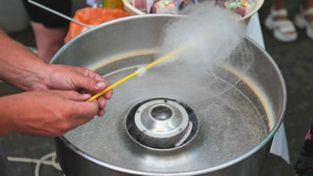 The process of making cotton candy on the street.の写真素材