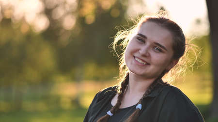 Portrait of a young girl on a warm summer day.の写真素材