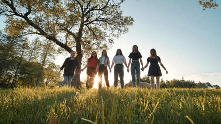 Girlfriends girls stand at sunset in the park.の写真素材