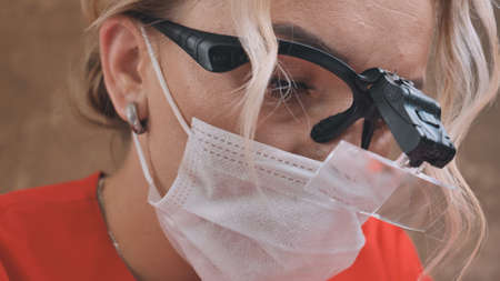Woman beautician works with a client in a cosmetology office.の写真素材