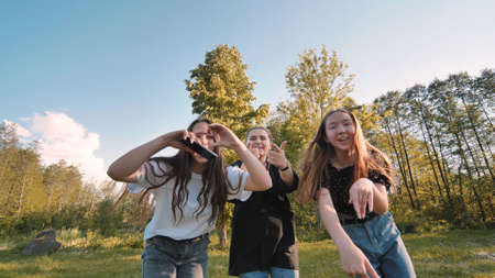 Girls blow a kiss at a picnic near the forest.の写真素材