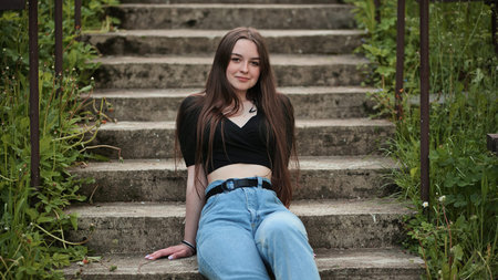 Nice girl posing while sitting on the stairs.