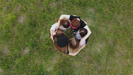 Friends hug in the park on a summer day. View from above.の写真素材
