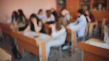 Pupils of the 11th grade in the class at the desks during the lesson. Russian school.