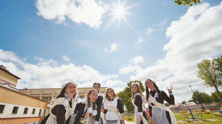 Happy Russian female graduates pose on their graduation day.の写真素材