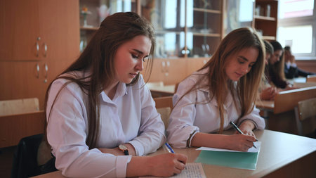 Pupils of the 11th grade in the class at the desks during the lesson. Russian school.