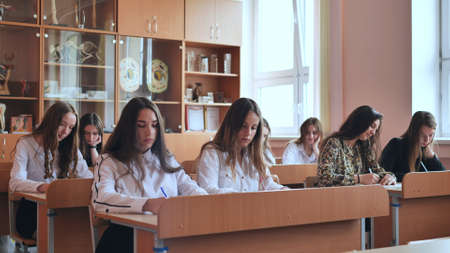 High school students sit at their desks during lessons.の写真素材