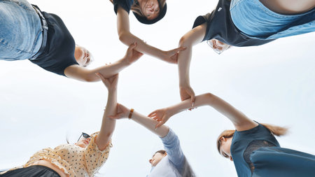 The girlfriends join the wrists in the center making a circle shape.
