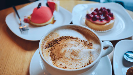 A table of cakes and coffee at a girls breakfast.