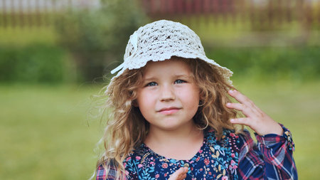Portrait of a little girl in a panama hat on a summer day.