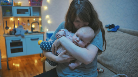 A loving mother with a baby in her arms at home.の写真素材