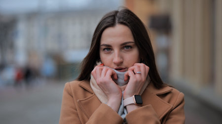 Portrait of a young girl freezing on a cold day.の写真素材
