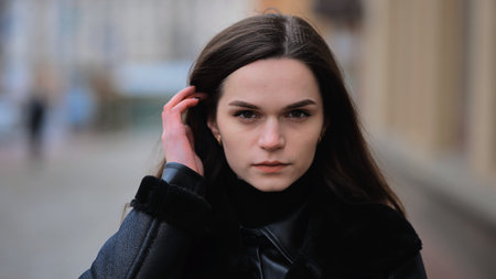 Portrait of a young girl on a city street in early spring.
