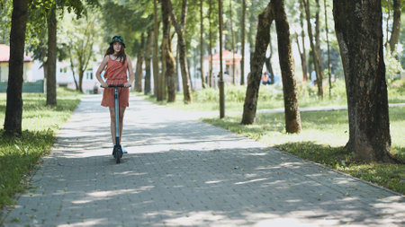 A girl rolls around on city tiles in the park.の写真素材