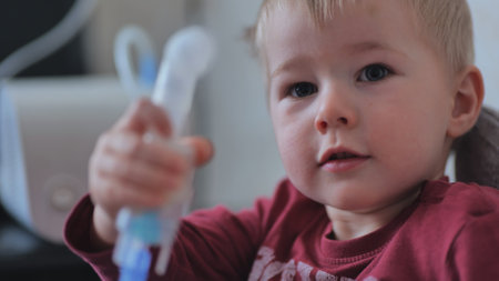 Funny boy breathing through an inhaler mask.の写真素材