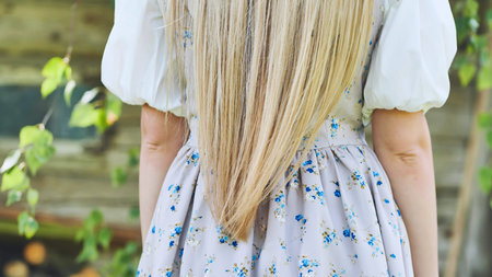 Blonde hair in a dress. View from the back.の写真素材