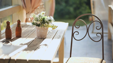 A vase of flowers on a table outside.の写真素材