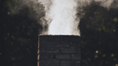White smoke from the chimney of the village house.