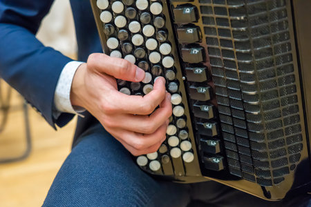 Musician playing black accordion with white keys close upの写真素材
