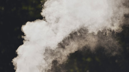 Dense white smoke rising against a dark backdrop, ideal for conveying concepts of fire, pollution, or intrigueの写真素材