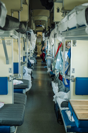 Passengers are relaxing on a third class carriage of a russian train, enjoying the journey and the passing landscapesの写真素材