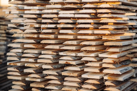 Wooden planks neatly stacking, creating textured surface, representing lumber industrys raw material...