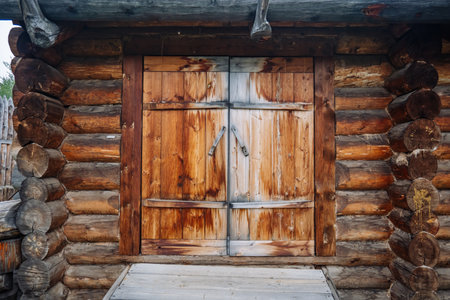 Weathered wooden door of a traditional log cabin, showcasing rural russian architecture and craftsmanshipの写真素材