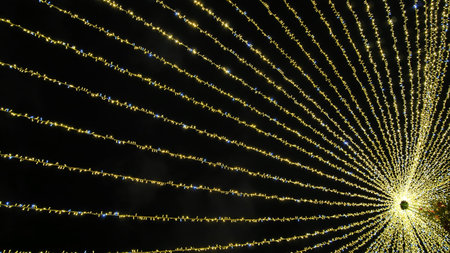 Hanging Christmas beams of garland in the city. New Years illumination.