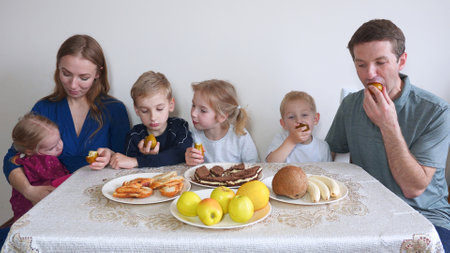 A large and friendly family has lunch at home.の写真素材
