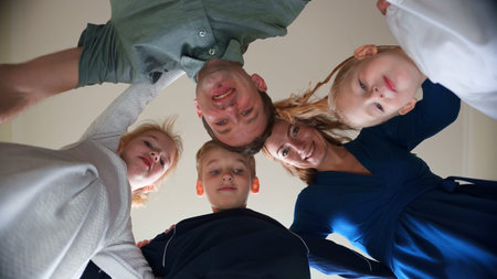 A large and friendly family hugs and poses.