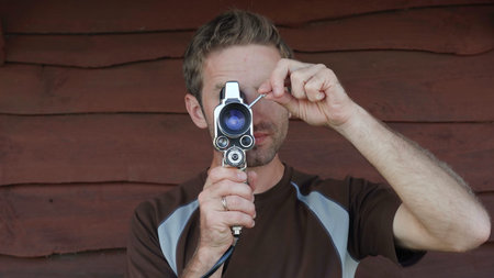 A young man makes a video on an old retro camera.