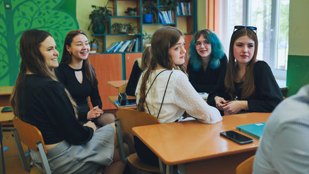 High school girls actively participating and engaging in discussions during a lessonの写真素材