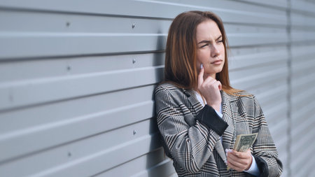 The girl makes up her mind to shop with her dollars.