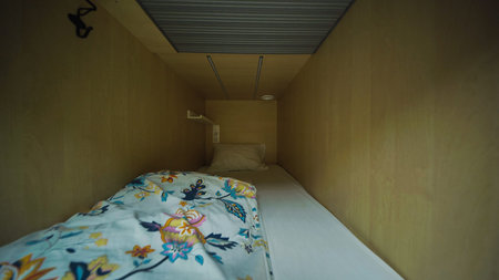 Cozy capsule hotel room inviting guests for comfortable rest