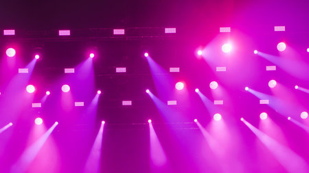 Purple stage lights illuminating the darkness creating a vibrant spectacleの写真素材